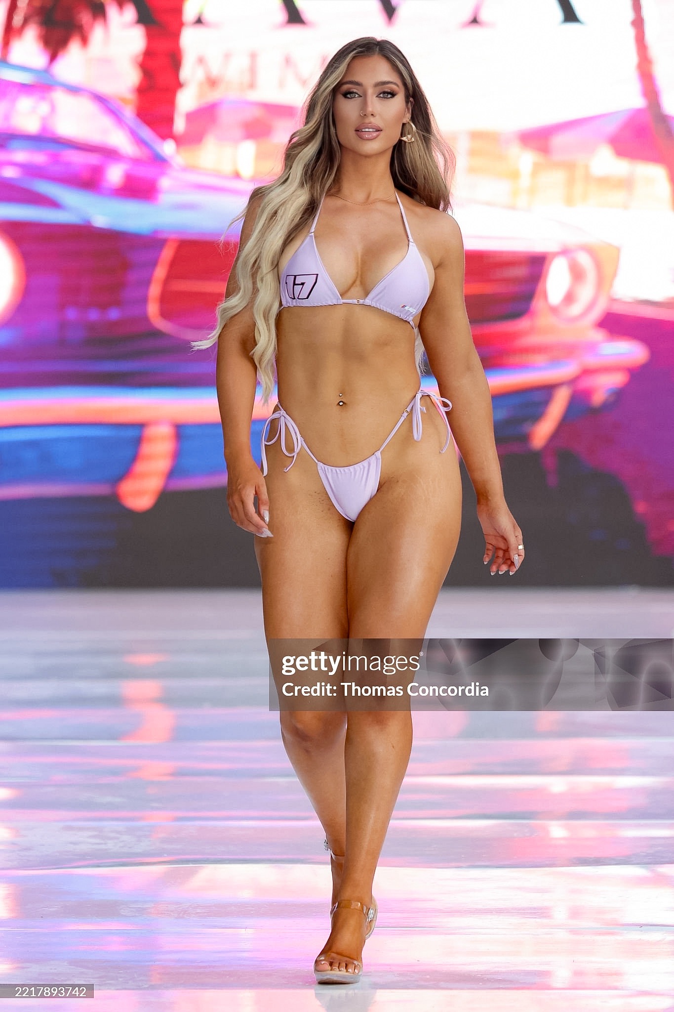 Model walking a runway during a live fashion show